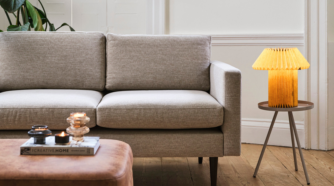 grey linen sofa with pleated paper table lamp