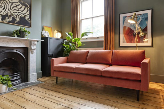 burnt orange sofa in small space 