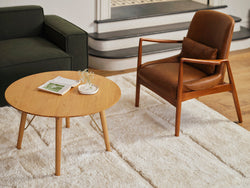 A tan occasional chair and a coffee table