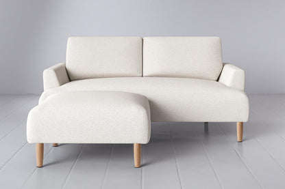 Ottoman in white bouclé with oak legs